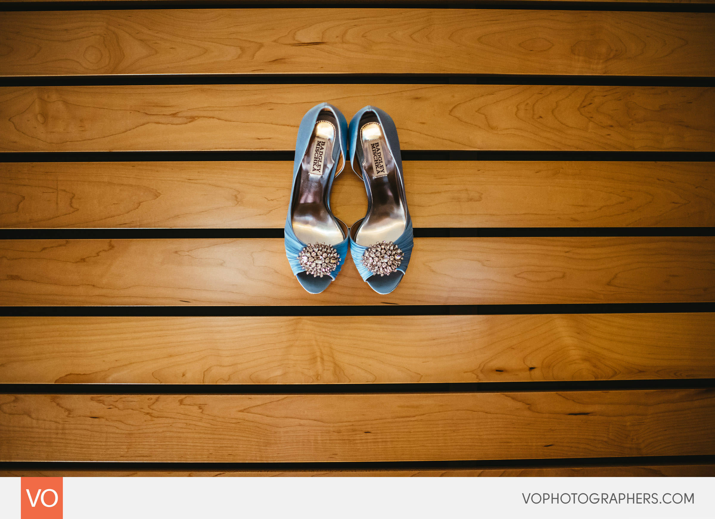 Bride's shoes hanging on bed headboard