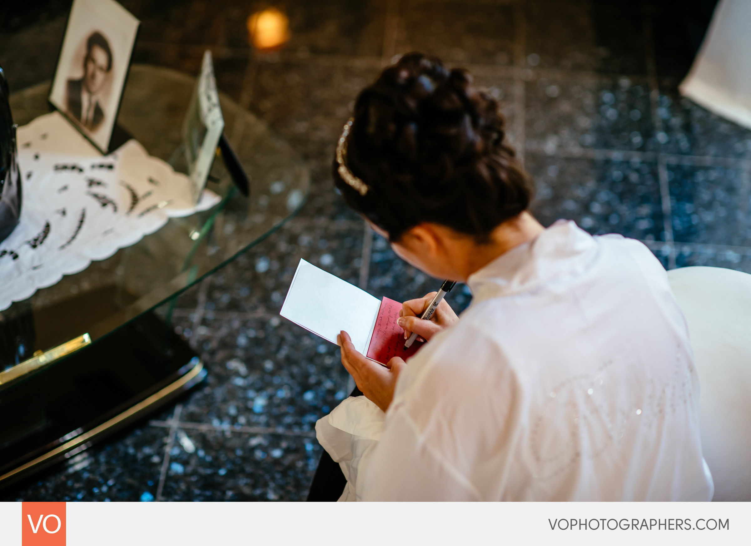 Bride writing a note to the groom on their wedding day